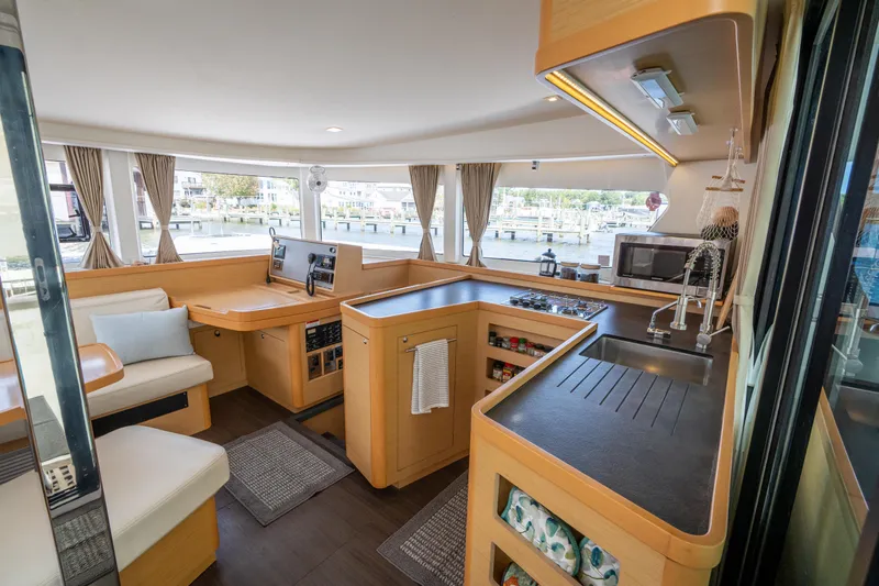 Slide: The Image of Interior of 2017 Lagoon 42 catamaran with modern kitchen and seating area. - 24