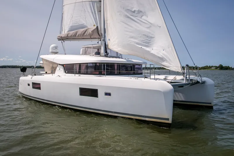 Slide: The Image of 2017 Lagoon 42 catamaran sailing on calm waters under clear skies. - 6