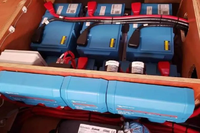 Slide: The Image of Electrical system components in a 2017 Lagoon 42 catamaran, featuring blue power units. - 80