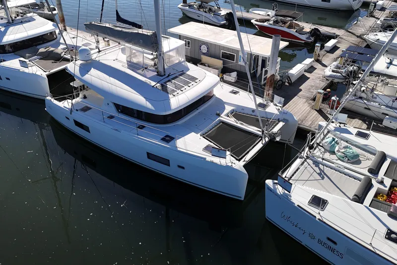 Slide: The Image of 2017 Lagoon 42 catamaran docked at marina, surrounded by other boats. - 85