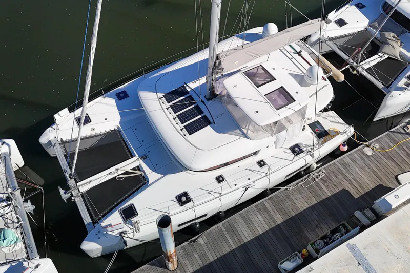 Slide: The Image of Aerial view of a 2017 Lagoon 42 catamaran docked at a marina. - 86