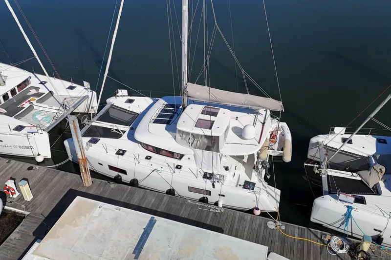 Slide: The Image of Aerial view of a 2017 Lagoon 42 catamaran docked at a marina. - 87