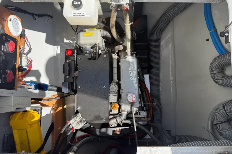 Slide: The Image of Engine compartment of a 2017 Lagoon 42 catamaran, showcasing mechanical components and wiring. - 97