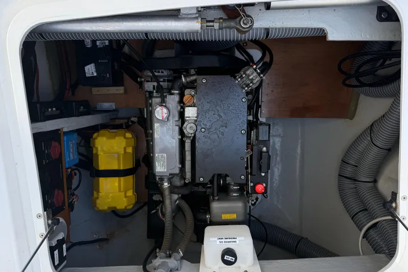 Slide: The Image of Engine compartment of a 2017 Lagoon 42 catamaran, showcasing mechanical components and wiring. - 98