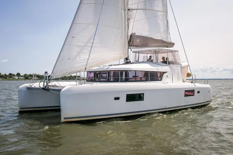Slide: The Image of 2017 Lagoon 42 catamaran sailing on open water under clear skies. - 12