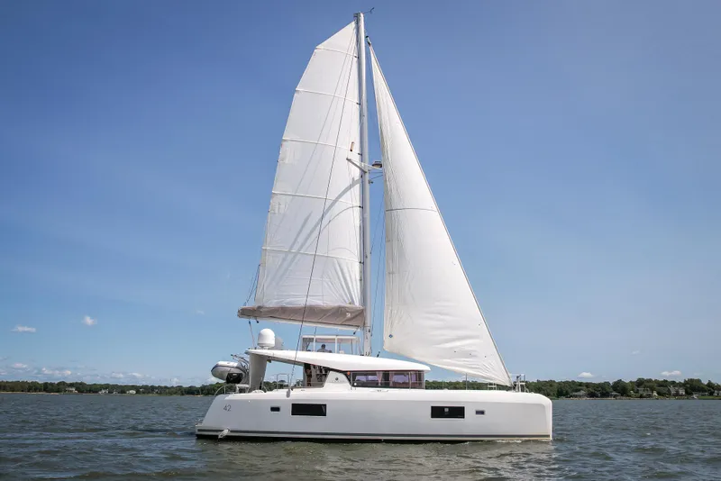 Slide: The Image of 2017 Lagoon 42 catamaran sailing on calm waters under clear blue skies. - 14