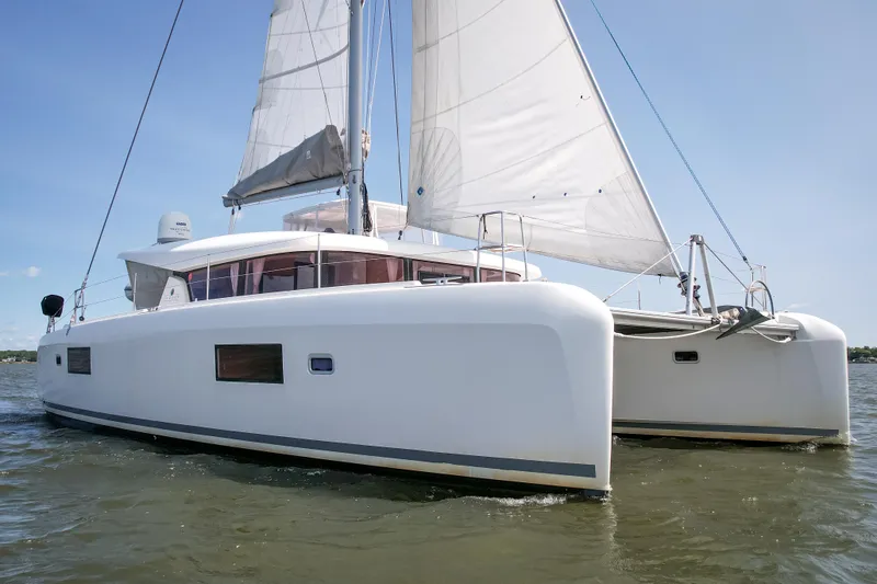 Slide: The Image of 2017 Lagoon 42 catamaran sailing on calm waters under clear blue skies. - 15