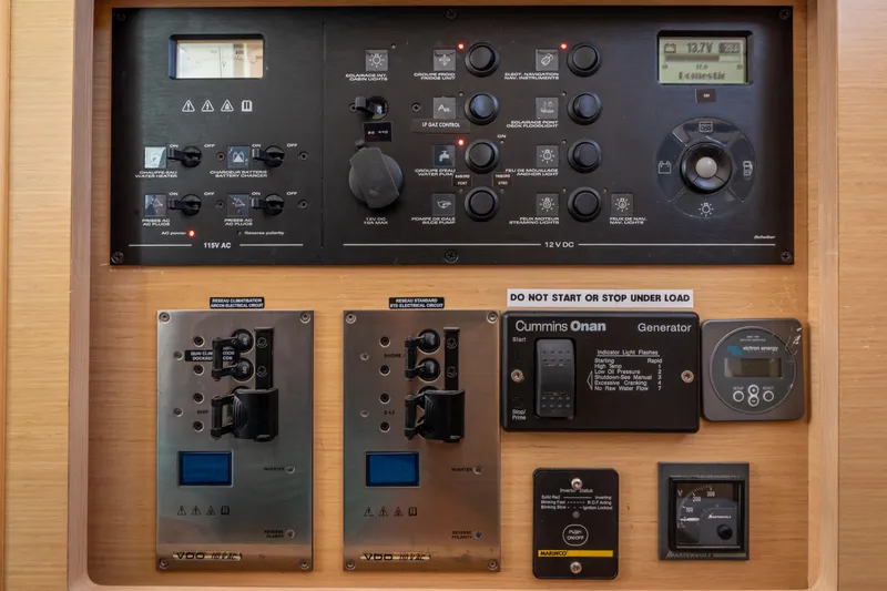 Slide: The Image of Control panel of a 2017 Lagoon 42 yacht, featuring various switches and gauges. - 31