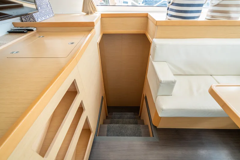 Slide: The Image of Interior of 2017 Lagoon 42 yacht with stairs, light wood, and white seating. - 44
