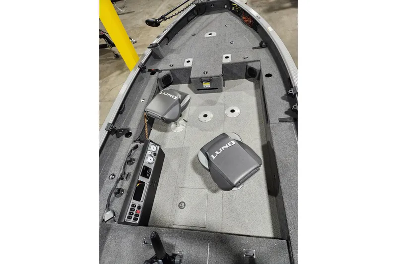 Slide: The Image of 2024 Lund 1875 Pro Guide boat interior with seating and control panel. - 10