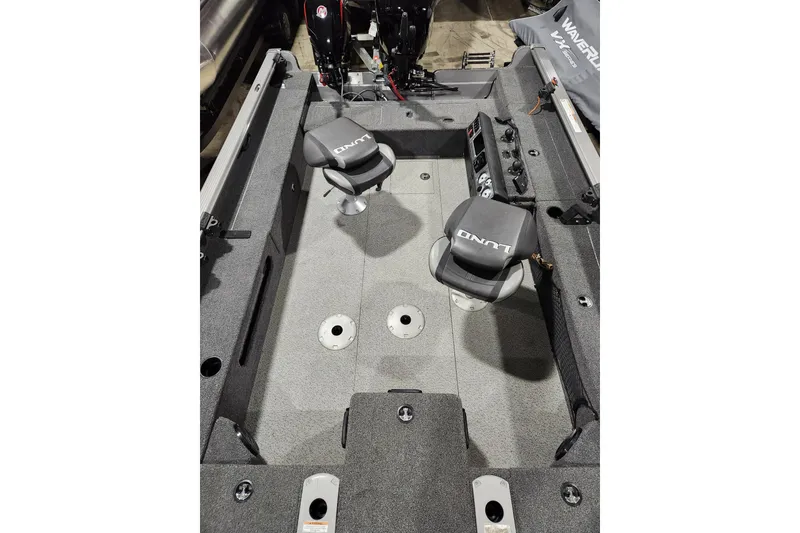 Slide: The Image of 2024 Lund 1875 Pro Guide boat interior with two seats and control panel. - 3