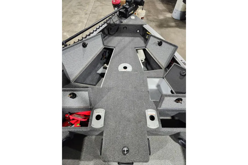 Slide: The Image of 2024 Lund 1875 Pro Guide boat interior with open storage compartments. - 9