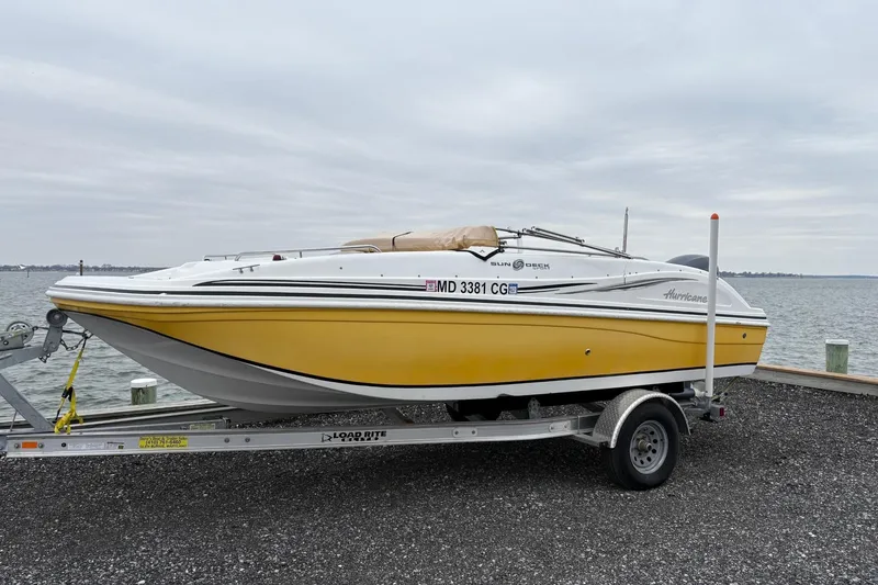 The Image of 2013 Hurricane SunDeck Sport 188 OB boat on trailer by waterfront. - 1