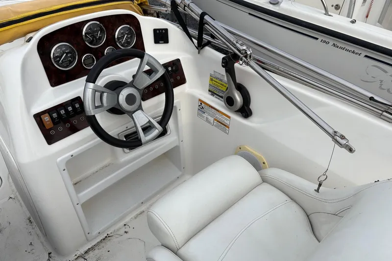 Slide: The Image of 2013 Hurricane SunDeck Sport 188 OB boat dashboard with steering wheel and gauges. - 5