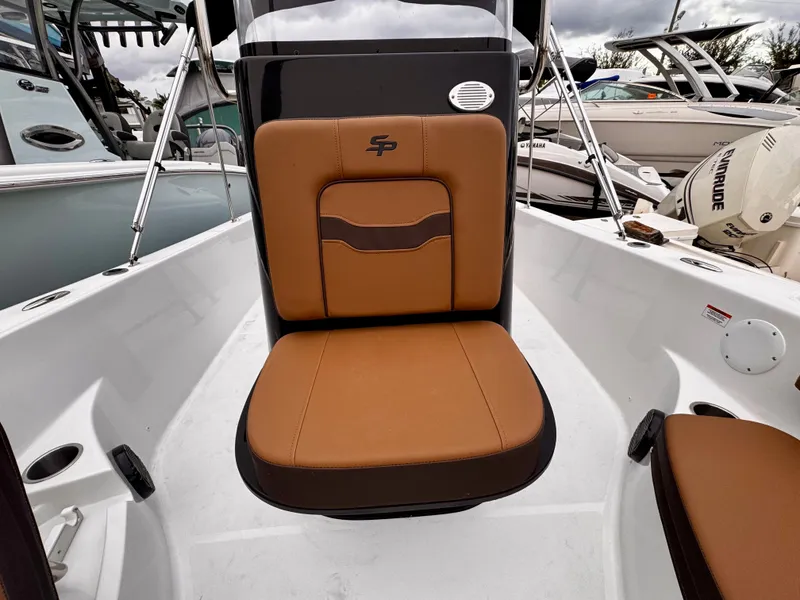 Slide: The Image of 2025 Sea Pro 202 Center Console boat with brown seating and sleek design. - 24