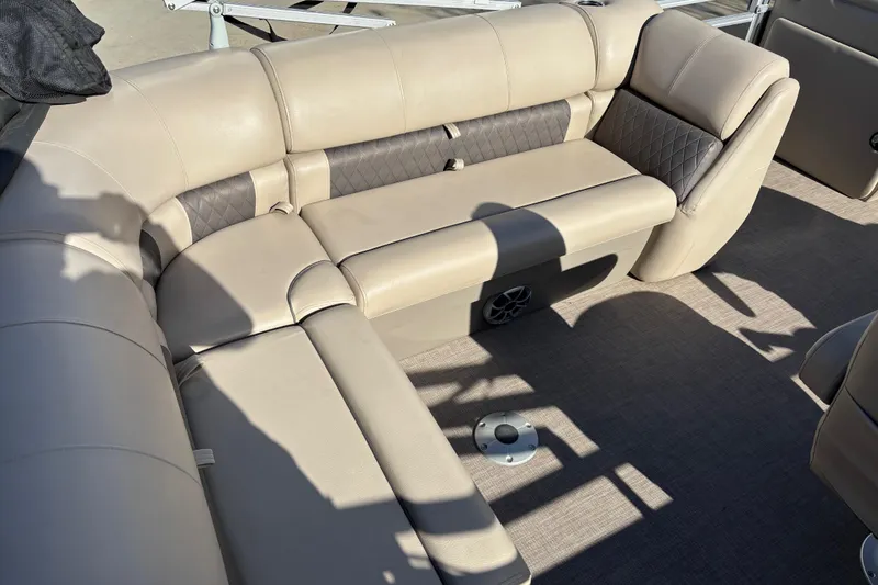 Slide: The Image of 2024 Sun Tracker Party Barge 20 DLX interior seating with beige upholstery. - 16