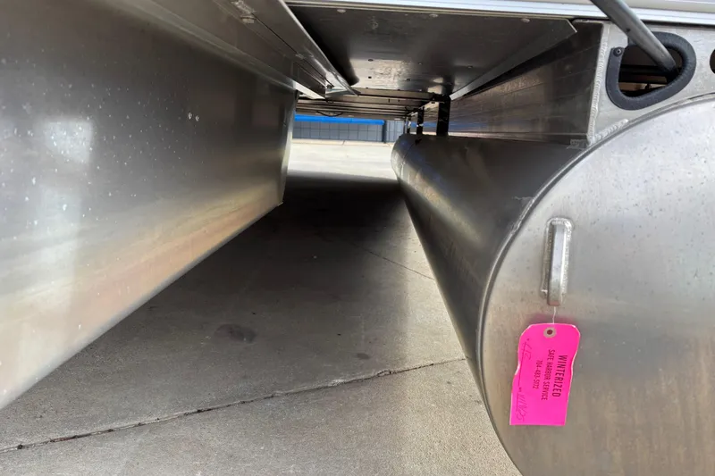 Slide: The Image of Underneath view of 2024 Sun Tracker Party Barge 20 DLX pontoon with winterization tag. - 18