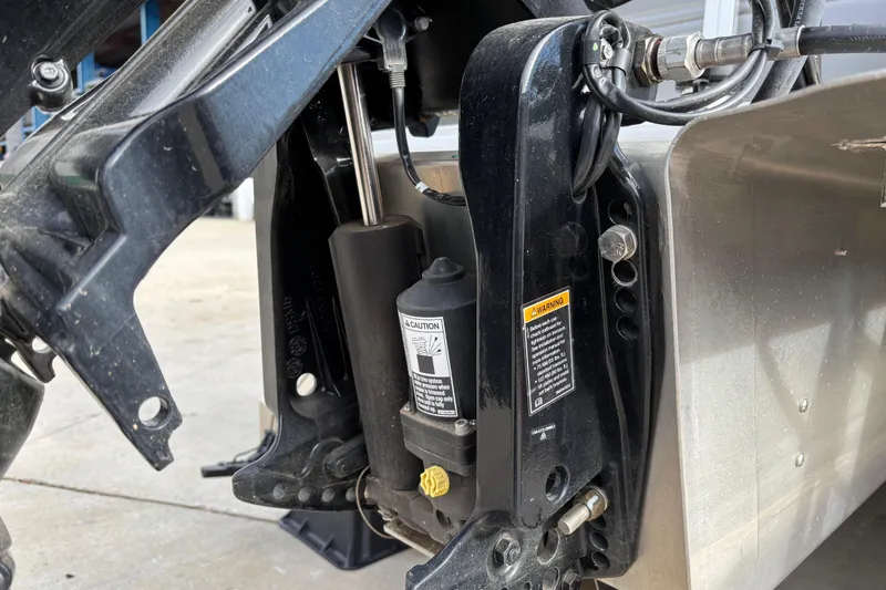 Slide: The Image of Close-up of 2024 Sun Tracker Party Barge 20 DLX engine components and hydraulic system. - 20