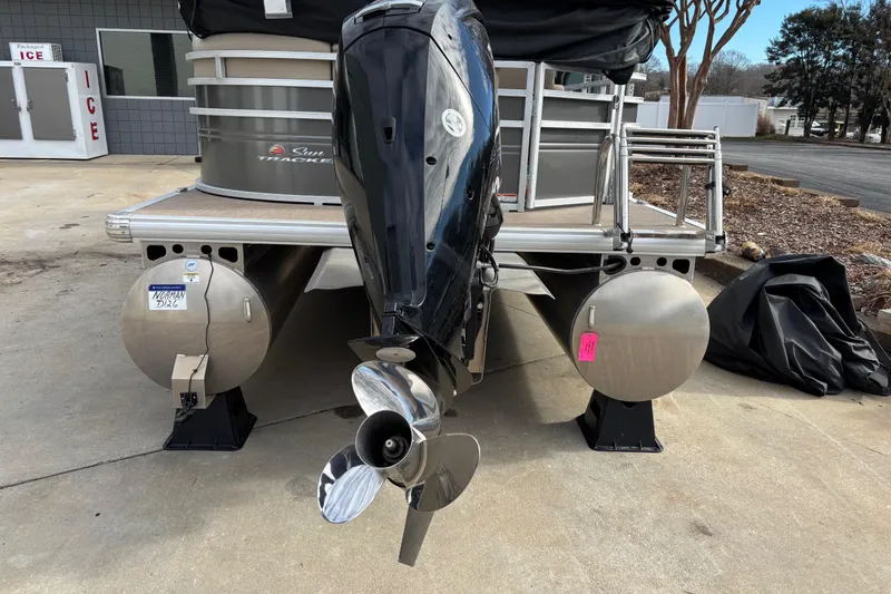 Slide: The Image of 2024 Sun Tracker Party Barge 20 DLX pontoon boat with outboard motor, rear view. - 5