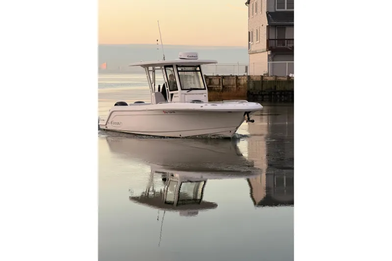The Image of 2020 Robalo R272 Center Console boat on calm water at sunset. - 0
