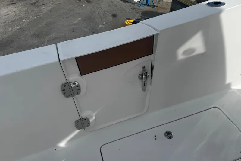 Slide: The Image of 2026 Sea Pro 262 Offshore boat deck with storage compartment and latch. - 11