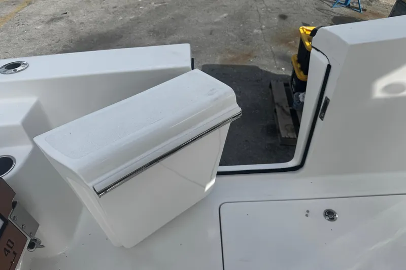 Slide: The Image of 2026 Sea Pro 262 Offshore boat deck with storage compartment and seating. - 12