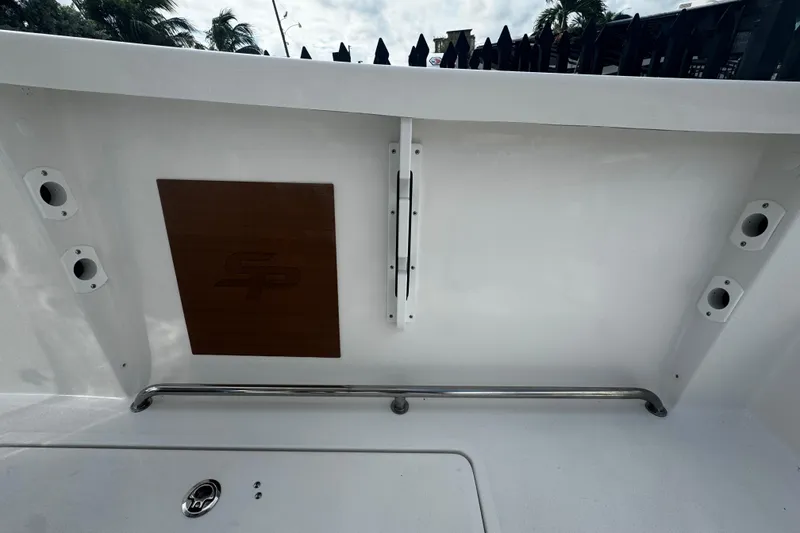 Slide: The Image of 2026 Sea Pro 262 Offshore boat interior with rod holders and storage compartment. - 16