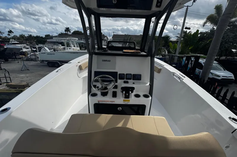 Slide: The Image of 2026 Sea Pro 262 Offshore boat interior with steering console and seating. - 17