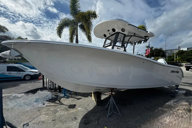 Slide: The Image of 2026 Sea Pro 262 Offshore boat on display, parked outdoors under a cloudy sky. - 3