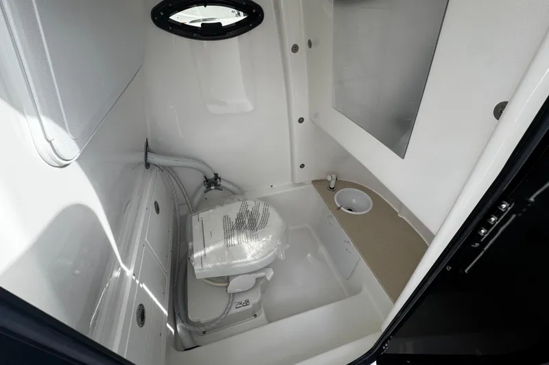 Slide: The Image of 2026 Sea Pro 262 Offshore boat bathroom with toilet and sink, compact and modern design. - 33