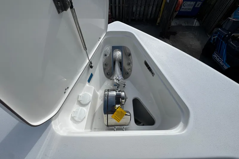 Slide: The Image of 2026 Sea Pro 262 Offshore anchor compartment with open hatch and visible winch. - 39