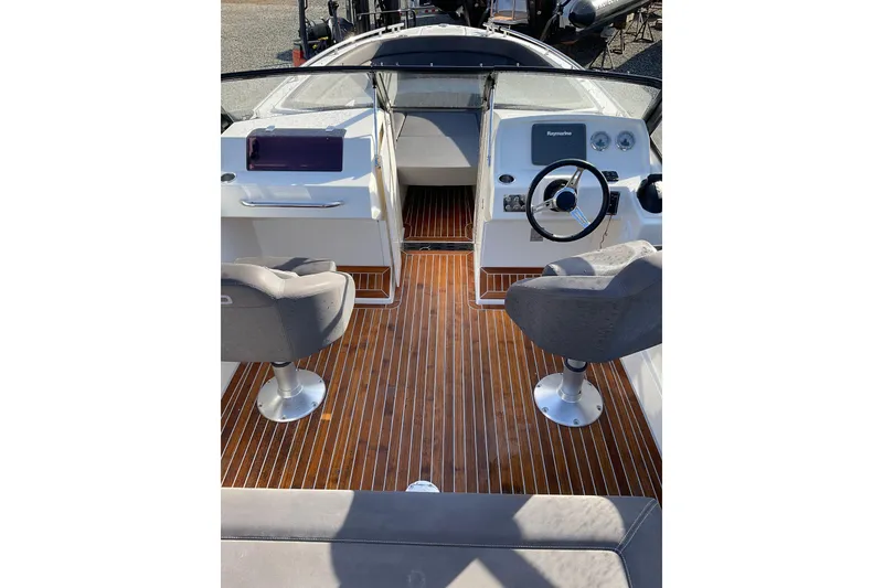 Slide: The Image of 2017 Draco 22RS boat interior with wooden flooring and dual seating. - 13