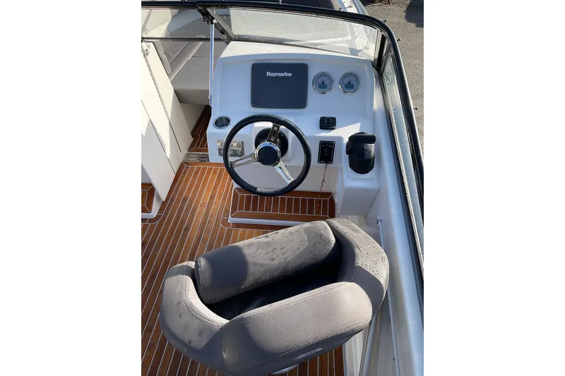 Slide: The Image of Cockpit of 2017 Draco 22RS boat with steering wheel and navigation system. - 14