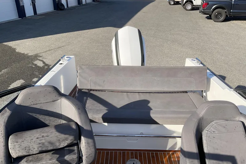 Slide: The Image of 2017 Draco 22RS boat interior with gray seating and wooden flooring. - 17