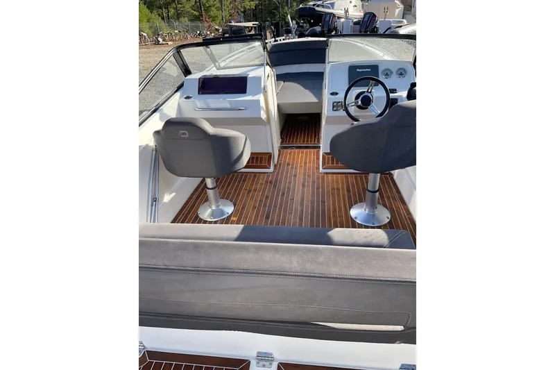 Slide: The Image of 2017 Draco 22RS boat interior with sleek seating and wooden flooring. - 18