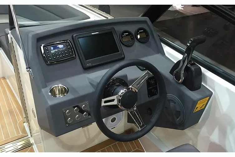Slide: The Image of Manufacturer Provided Image: Control panel of a 2018 Draco 22RS boat with steering wheel and navigation equipment. - 4