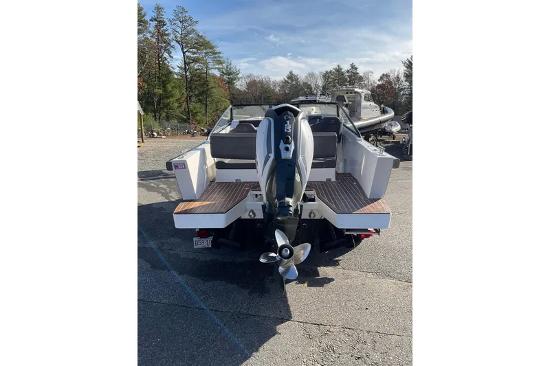Slide: The Image of Rear view of 2017 Draco 22RS boat with outboard motor in a marina setting. - 8