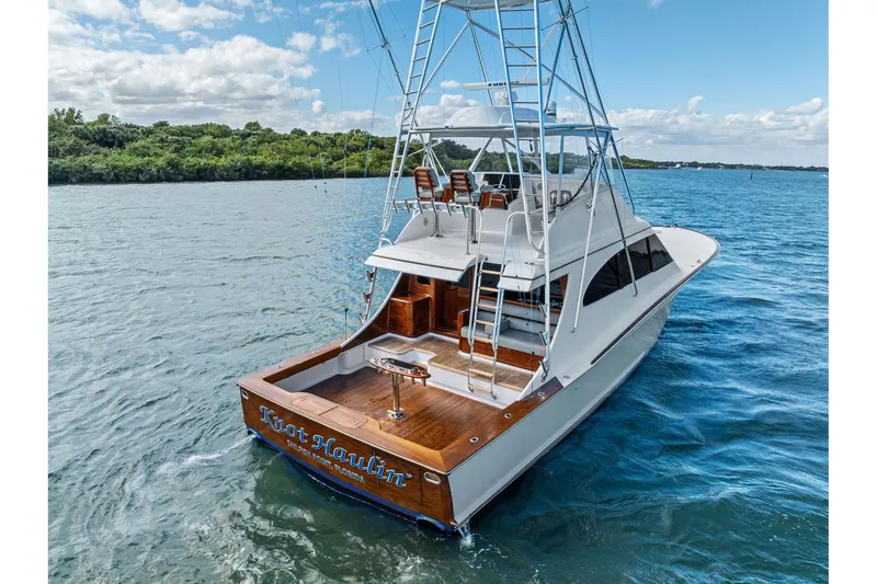 Slide: The Image of 2017 Spencer Convertible yacht on water, featuring a sleek design and spacious deck. - 13