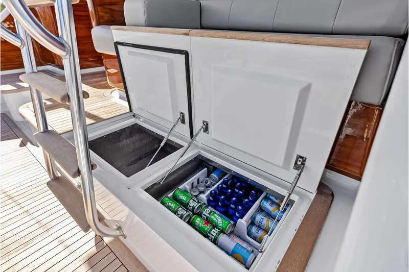 Slide: The Image of Built-in cooler on 2017 Spencer Convertible yacht, stocked with beverages, open on teak deck. - 22