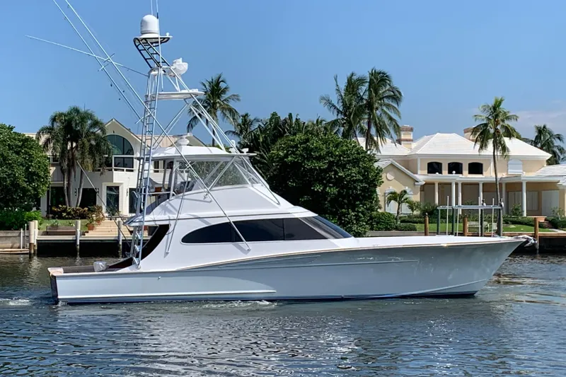Slide: The Image of 2017 Spencer Convertible yacht cruising on open blue waters under a clear sky. - 4