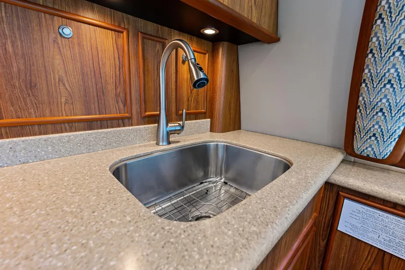 Slide: The Image of Luxurious kitchen sink in 2017 Spencer Convertible yacht with wood paneling and modern faucet. - 41