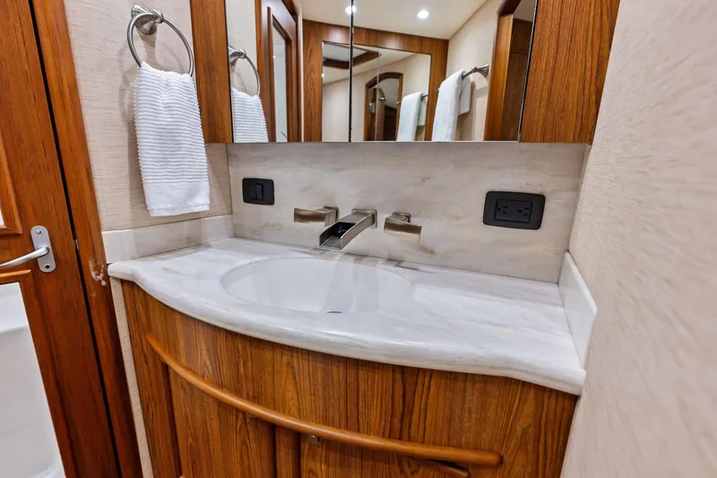 Slide: The Image of Luxurious bathroom vanity in 2017 Spencer Convertible yacht, featuring wood accents and modern fixtures. - 49