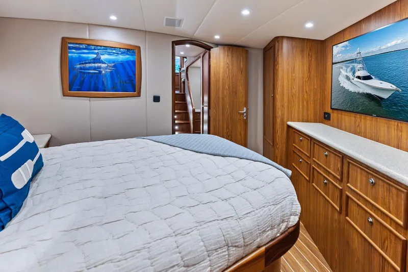 Slide: The Image of Luxurious 2017 Spencer Convertible yacht bedroom with wooden cabinetry and marine-themed artwork. - 52