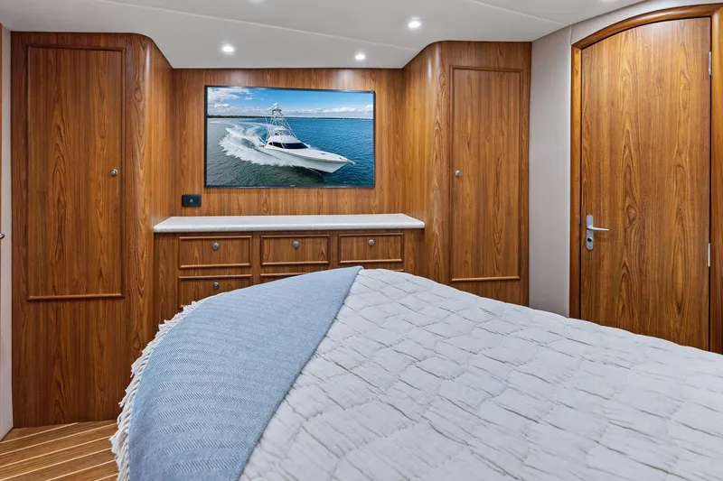 Slide: The Image of Luxurious 2017 Spencer Convertible yacht interior with wood paneling and cozy bedding. - 54