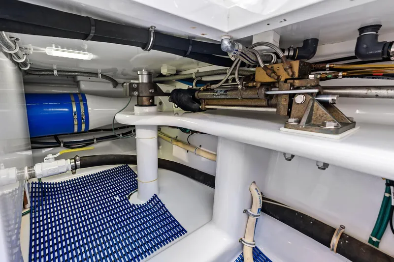 Slide: The Image of 2017 Spencer Convertible yacht engine room with hydraulic systems and blue mat flooring. - 67