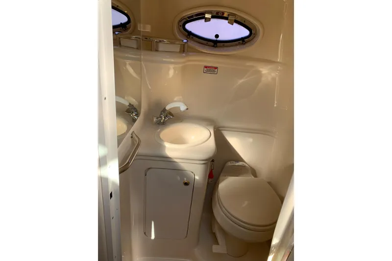 Slide: The Image of Compact bathroom in 2004 Sea Ray 260 Sundancer boat with sink and toilet. - 10