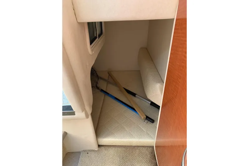 Slide: The Image of 2004 Sea Ray 260 Sundancer cabin interior with cleaning tools on the floor. - 11