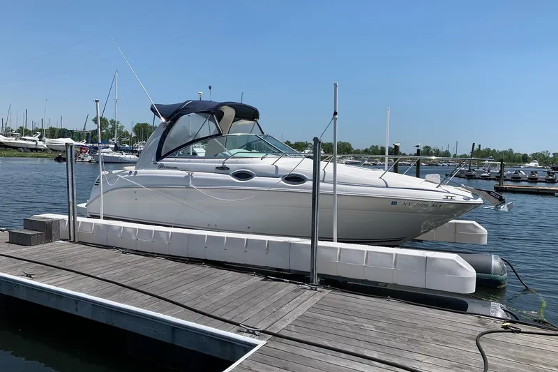 The Image of 2004 Sea Ray 260 Sundancer docked at marina on a sunny day. - 4