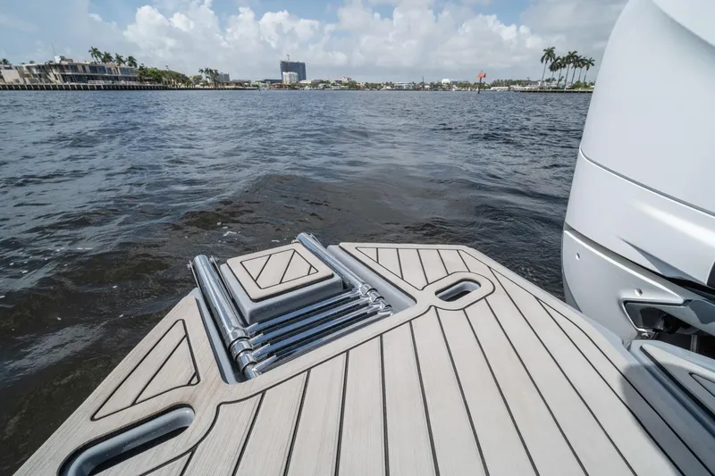Slide: The Image of Sleek Hanover 387 boat deck, 2026 model, overlooking calm waters and distant shoreline. - 12