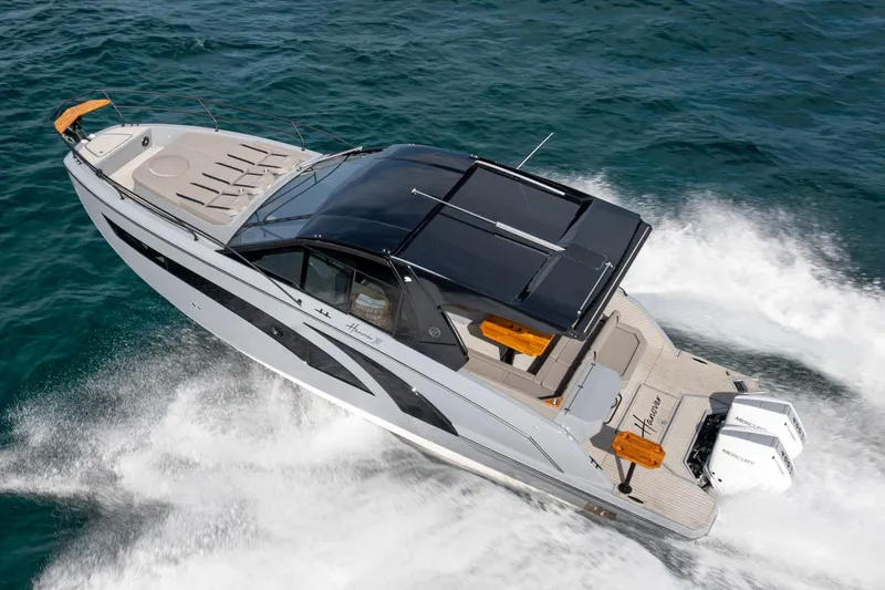 Slide: The Image of 2026 Hanover 387 boat cruising on open water, showcasing sleek design and powerful engines. - 3